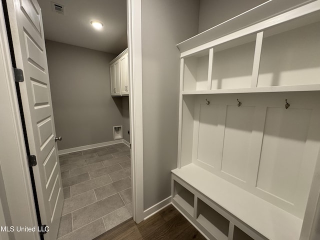 mudroom with visible vents, baseboards, and dark wood-style floors