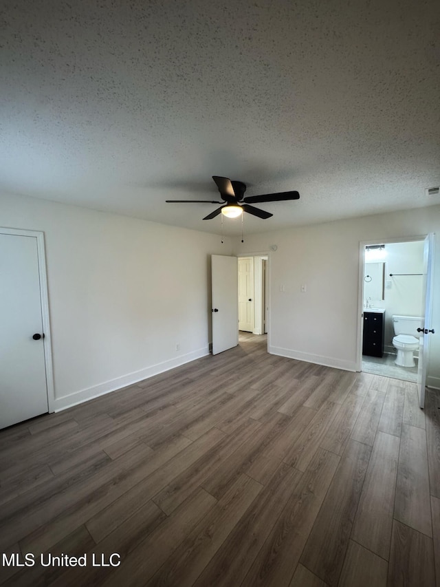 spare room featuring ceiling fan, a textured ceiling, and hardwood / wood-style flooring