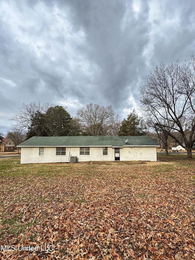 rear view of house featuring central AC unit