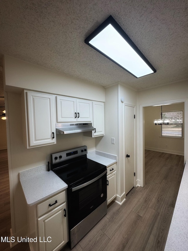 kitchen with stainless steel range with electric stovetop, a textured ceiling, a chandelier, dark hardwood / wood-style floors, and white cabinetry