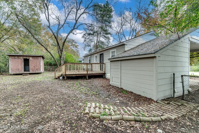 exterior space with a shed and a wooden deck