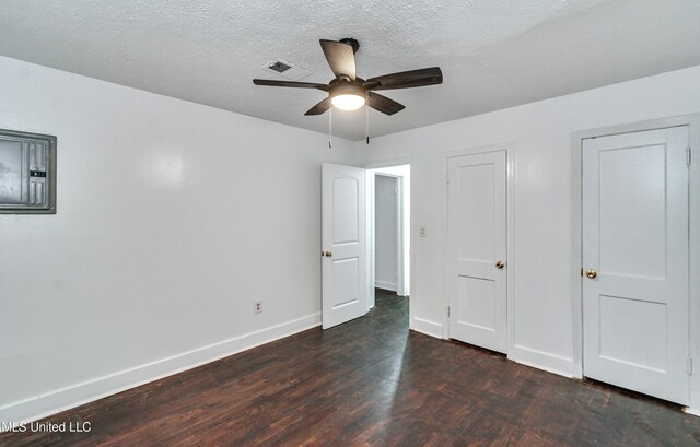 unfurnished bedroom featuring a textured ceiling, ceiling fan, and dark wood-type flooring