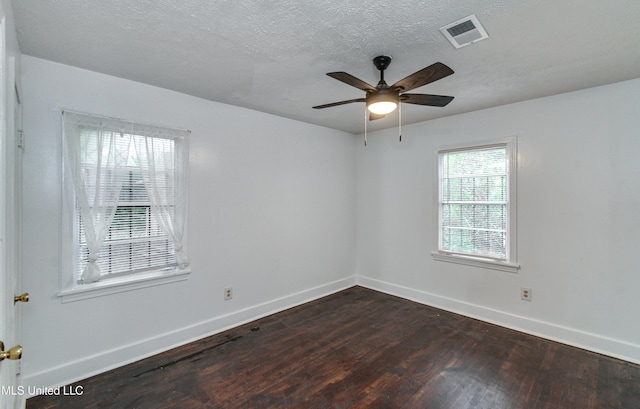 spare room featuring a textured ceiling, dark hardwood / wood-style flooring, and ceiling fan