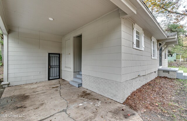 entrance to property featuring a patio