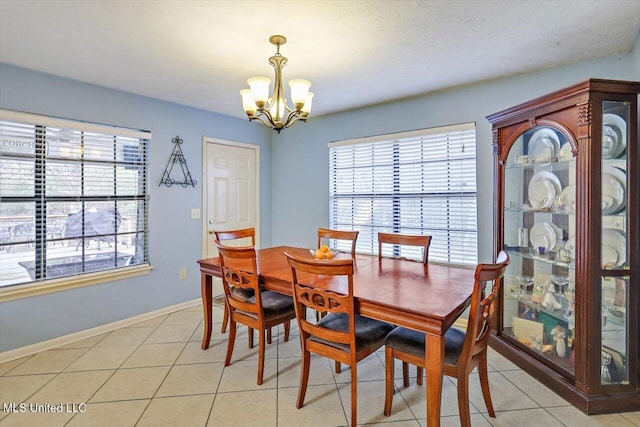 tiled dining area with an inviting chandelier