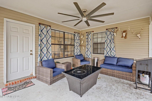 living room with ceiling fan and wood walls