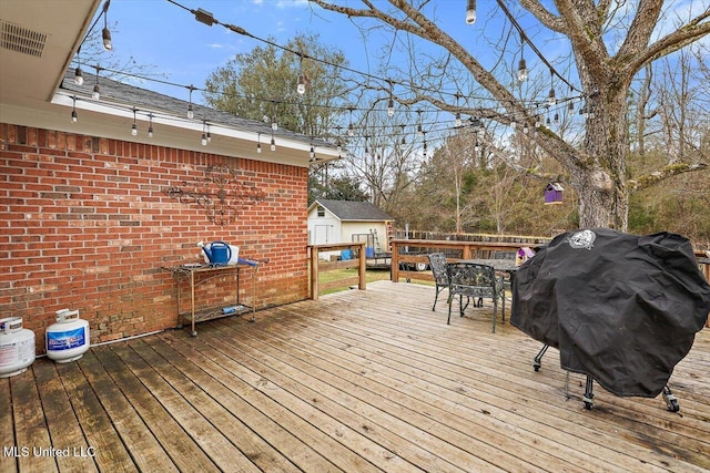 wooden deck featuring area for grilling