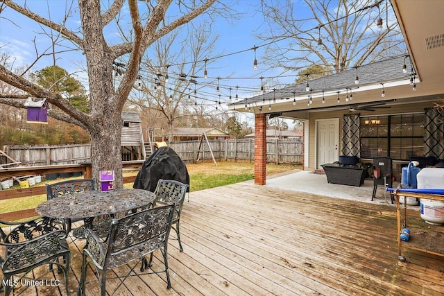 wooden deck with a patio