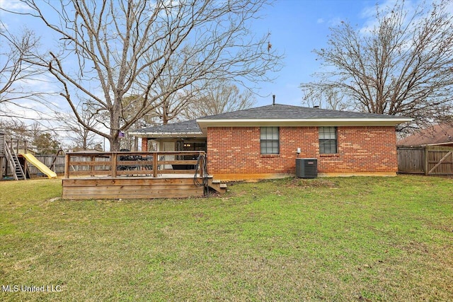 rear view of house featuring cooling unit, a playground, a wooden deck, and a yard