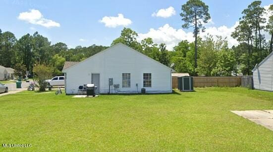 10557 Sharp Blvd, Gulfport, MS 39503 - rear view of property featuring a storage unit, an outdoor structure, and cooling unit