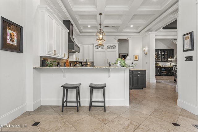 1511 18th Ave, Gulfport, MS 39501 - kitchen featuring premium range hood, a kitchen bar, crown molding, a peninsula, and white cabinetry