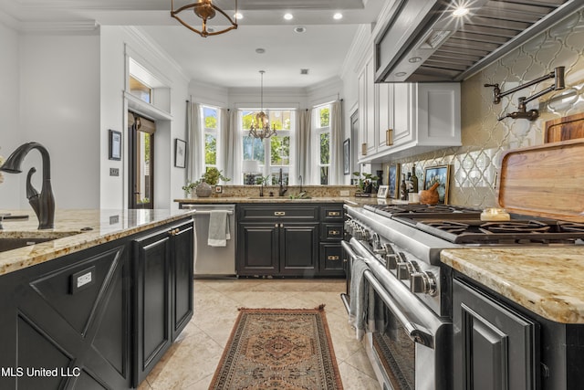 1511 18th Ave, Gulfport, MS 39501 - kitchen with stainless steel appliances, dark cabinetry, a chandelier, wall chimney range hood, and a sink