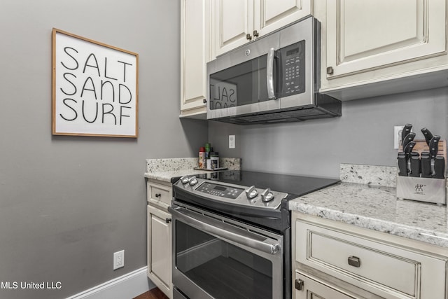 1511 18th Ave, Gulfport, MS 39501 - kitchen featuring stainless steel appliances, light stone countertops, and cream cabinetry