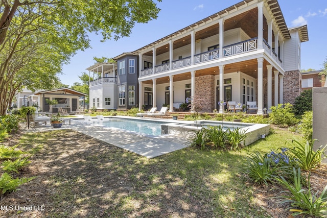 1511 18th Ave, Gulfport, MS 39501 - back of property featuring a patio, a balcony, an outdoor pool, and brick siding