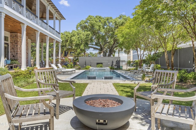 1511 18th Ave, Gulfport, MS 39501 - view of patio featuring an outdoor fire pit, an in-ground hot tub, and a balcony