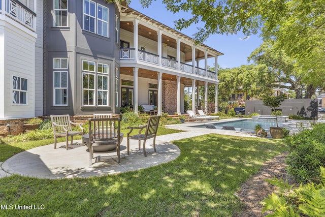 1511 18th Ave, Gulfport, MS 39501 - rear view of house featuring a balcony, a patio area, and a lawn