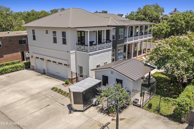 1511 18th Ave, Gulfport, MS 39501 - rear view of house with a balcony, an attached garage, driveway, and metal roof