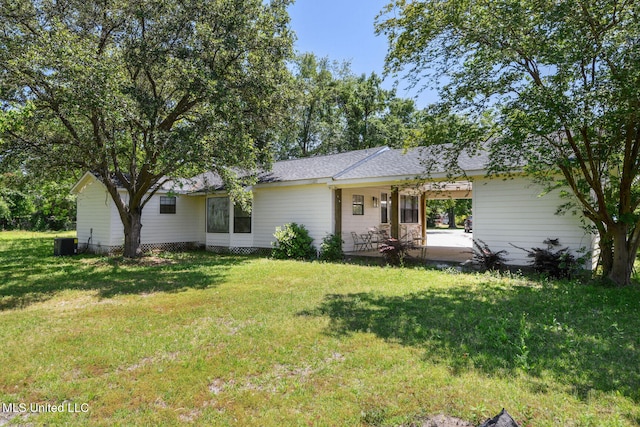 ranch-style home with central air condition unit, a patio, and a front yard