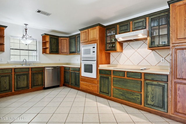 kitchen featuring white appliances, light tile patterned flooring, sink, and decorative light fixtures