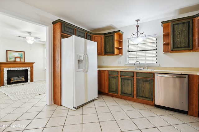 kitchen featuring hanging light fixtures, ceiling fan, white fridge with ice dispenser, stainless steel dishwasher, and sink