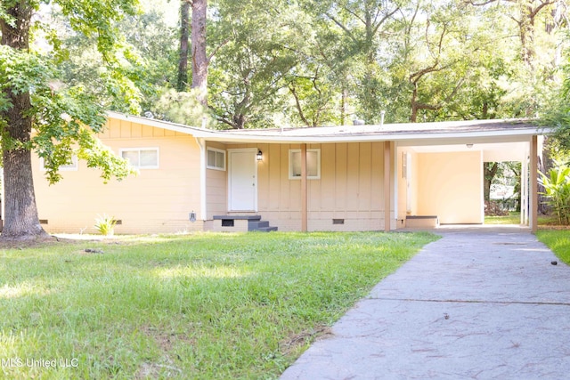 single story home with a front yard and a carport