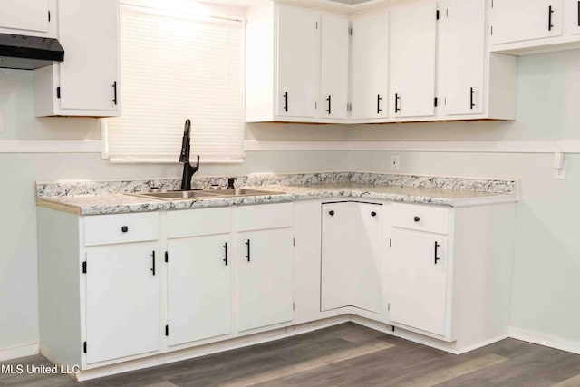 kitchen featuring dark hardwood / wood-style floors, white cabinetry, and sink