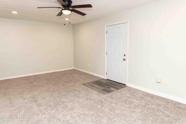 carpeted empty room featuring ceiling fan