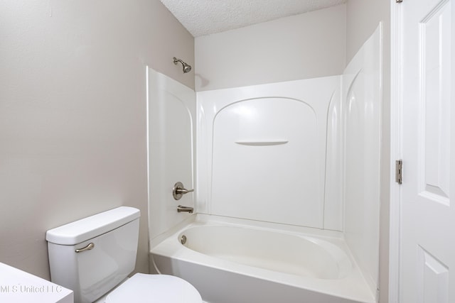 7241 Illinois Central Ave, Horn Lake, MS 38637 - bathroom featuring a textured ceiling, toilet, and tub / shower combination