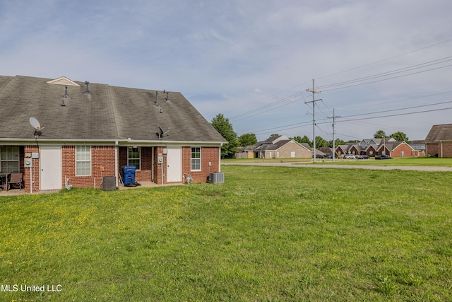 7241 Illinois Central Ave, Horn Lake, MS 38637 - back of property with brick siding, central AC unit, and a lawn