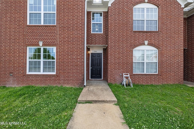 7241 Illinois Central Ave, Horn Lake, MS 38637 - view of front facade with a front lawn and brick siding