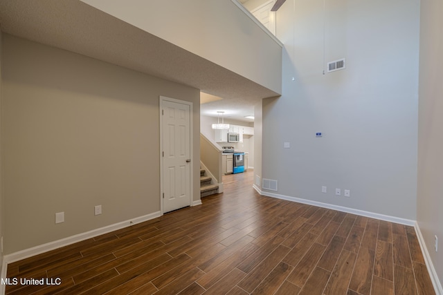 7241 Illinois Central Ave, Horn Lake, MS 38637 - empty room featuring dark wood-type flooring, stairs, and baseboards