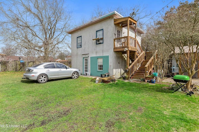 rear view of property with a yard and a wooden deck