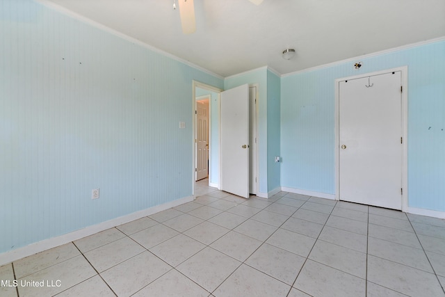 tiled spare room with crown molding