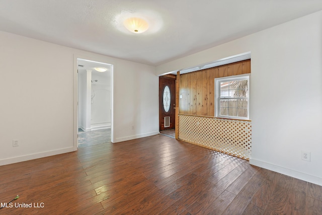 spare room featuring dark hardwood / wood-style floors