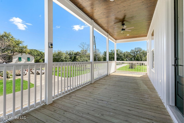 wooden terrace with a yard and ceiling fan