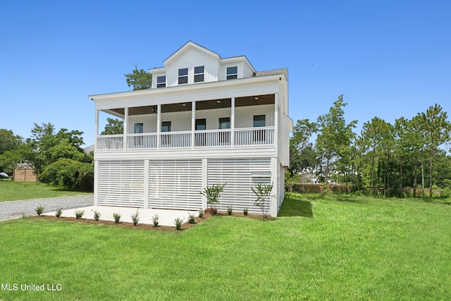 view of side of home featuring a yard and a balcony