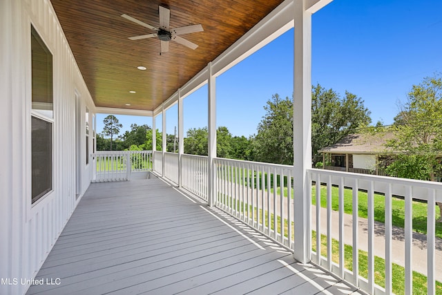 wooden terrace with a yard and ceiling fan