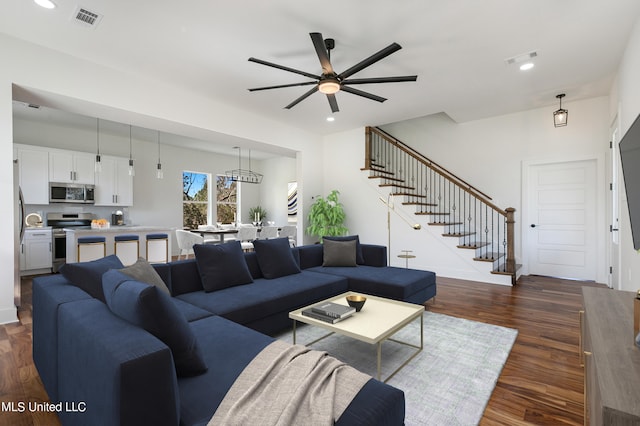 living room with dark wood-type flooring and ceiling fan