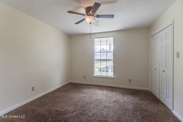 115 Shady Dr, Long Beach, MS 39560 - unfurnished bedroom with carpet floors, a textured ceiling, a closet, and ceiling fan