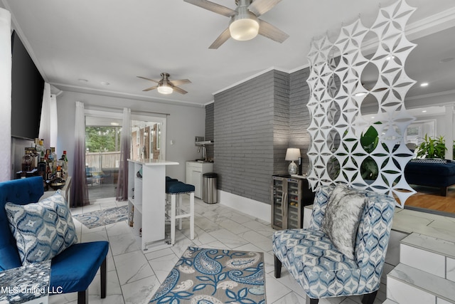 living room with brick wall, crown molding, light hardwood / wood-style flooring, and ceiling fan