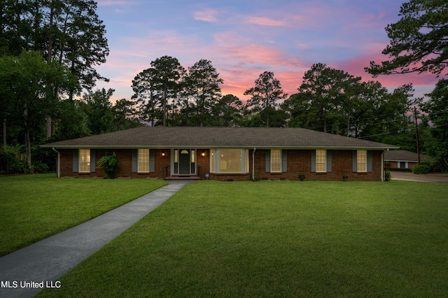 single story home featuring a yard