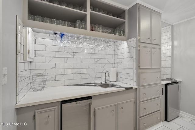 kitchen with dishwasher, ornamental molding, sink, gray cabinets, and tasteful backsplash