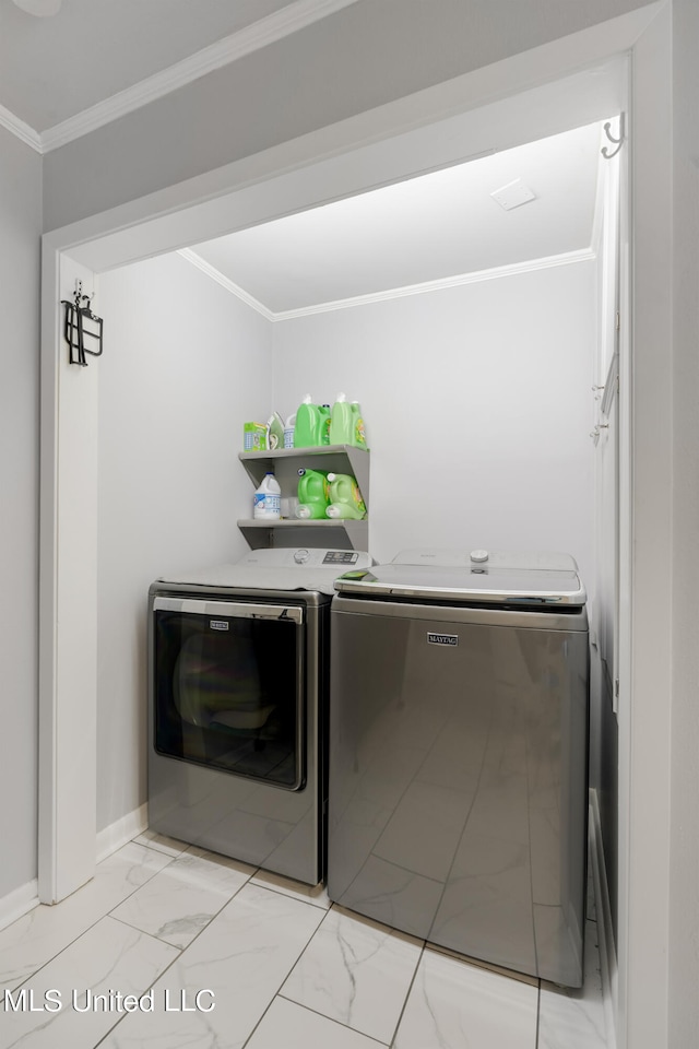 clothes washing area with ornamental molding and washing machine and clothes dryer