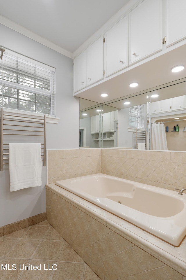 bathroom featuring tile patterned floors, ornamental molding, and tiled tub