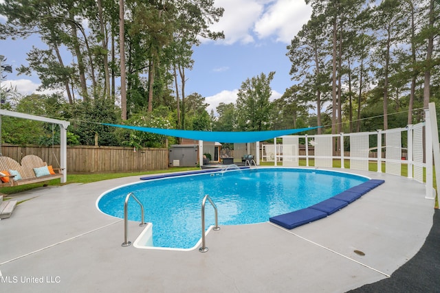 view of swimming pool with a patio area