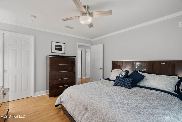 bedroom featuring ornamental molding, light hardwood / wood-style flooring, and ceiling fan