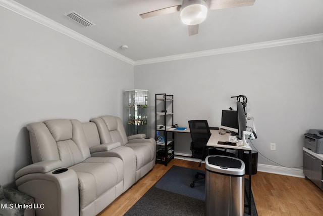 office with light hardwood / wood-style floors, ornamental molding, and ceiling fan