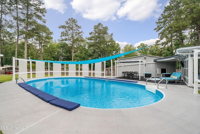 view of swimming pool featuring a patio area