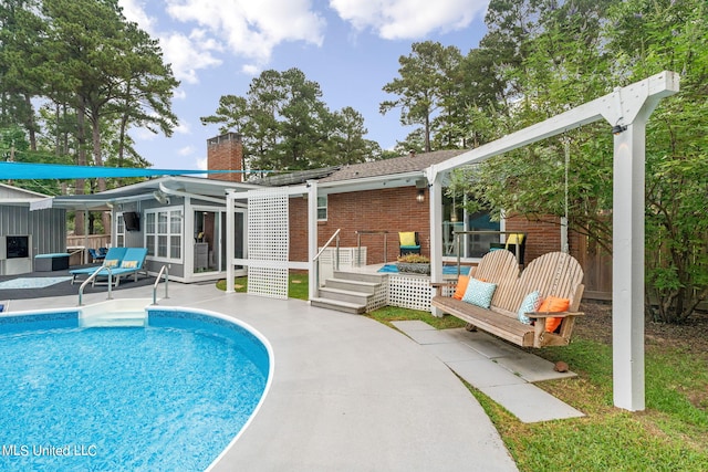 view of pool with a deck and a patio area