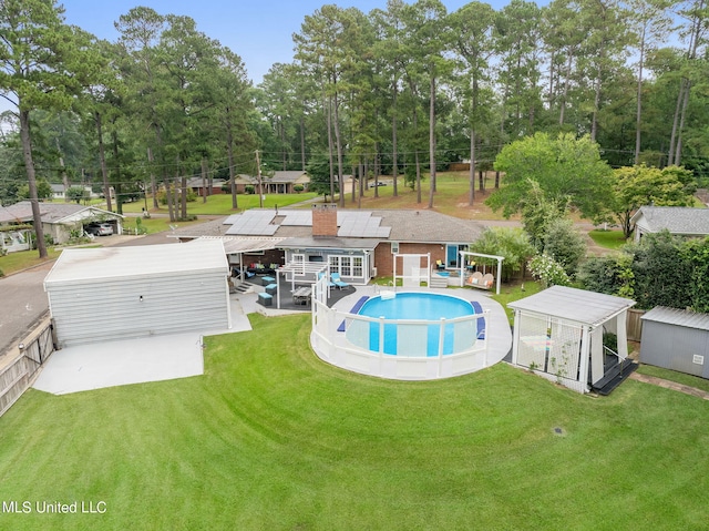 exterior space with a yard, a storage shed, and a patio area